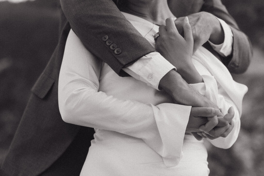 Close up shot of a couple inner locking hands and hugging on their wedding day in Skopelos Greece.